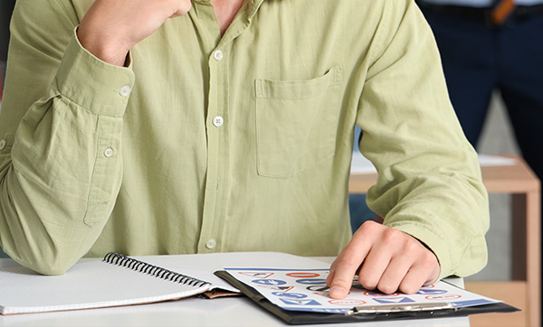 a checklist on a clipboard with a pencil next to it to track seven tasks or goals